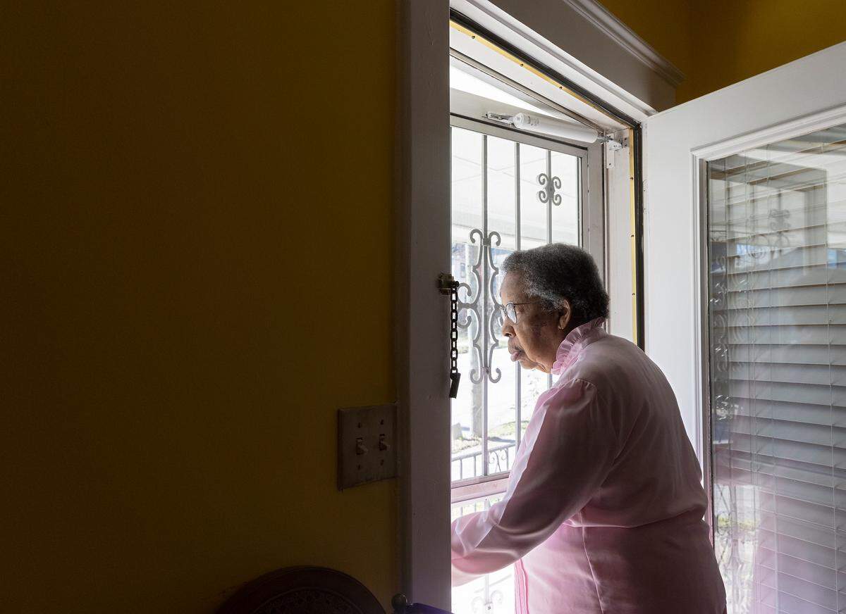 Doris Williams, 91, looks out her door of her Raleigh home on Thursday, Jan. 26, 2023. Williams, who first moved to the house when she was five years old, says she can remember when a horse-drawn cart traveled the street.