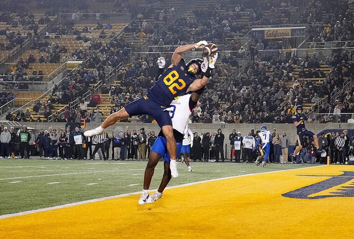 Cole Boscia (82) of the California Golden Bears catches a touchdown pass over Ahmaad Moses (3) of the Southern Methodist University Mustangs in the third quarter at California Memorial Stadium on Nov. 29, 2025, in Berkeley, California.