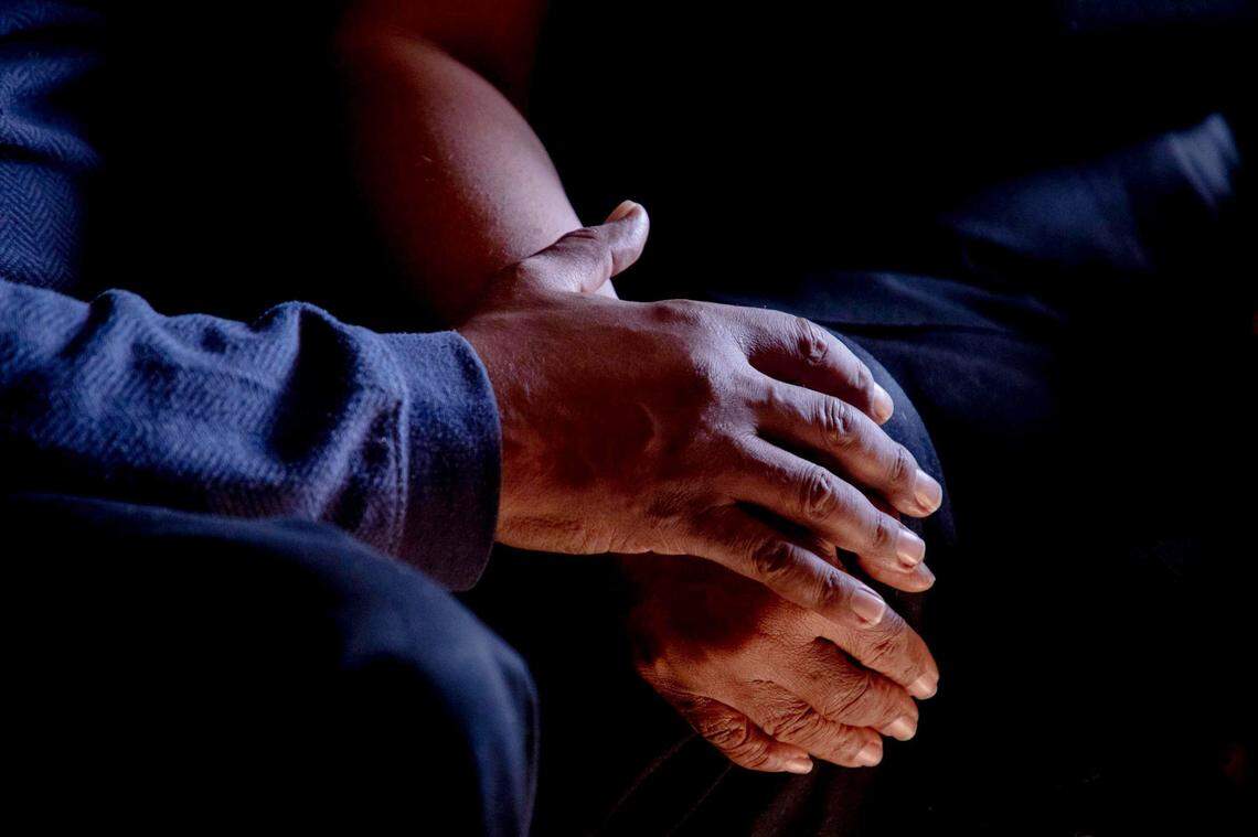 David McShaw, left, and wife Jacqueline McShaw hold hands while co-pastoring a Sunday morning church service together over a Zoom video call in their home while they each continue to recover from a COVID-19 infection, for which David spent 49 days in the hospital, on Sunday, Nov. 22, 2020, in Oxford, N.C.