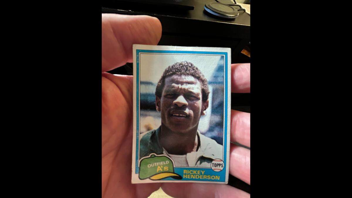 Josh Shaffer holds his 1982 Rickey Henderson baseball card on the day he learned of the Hall of Famer’s death.