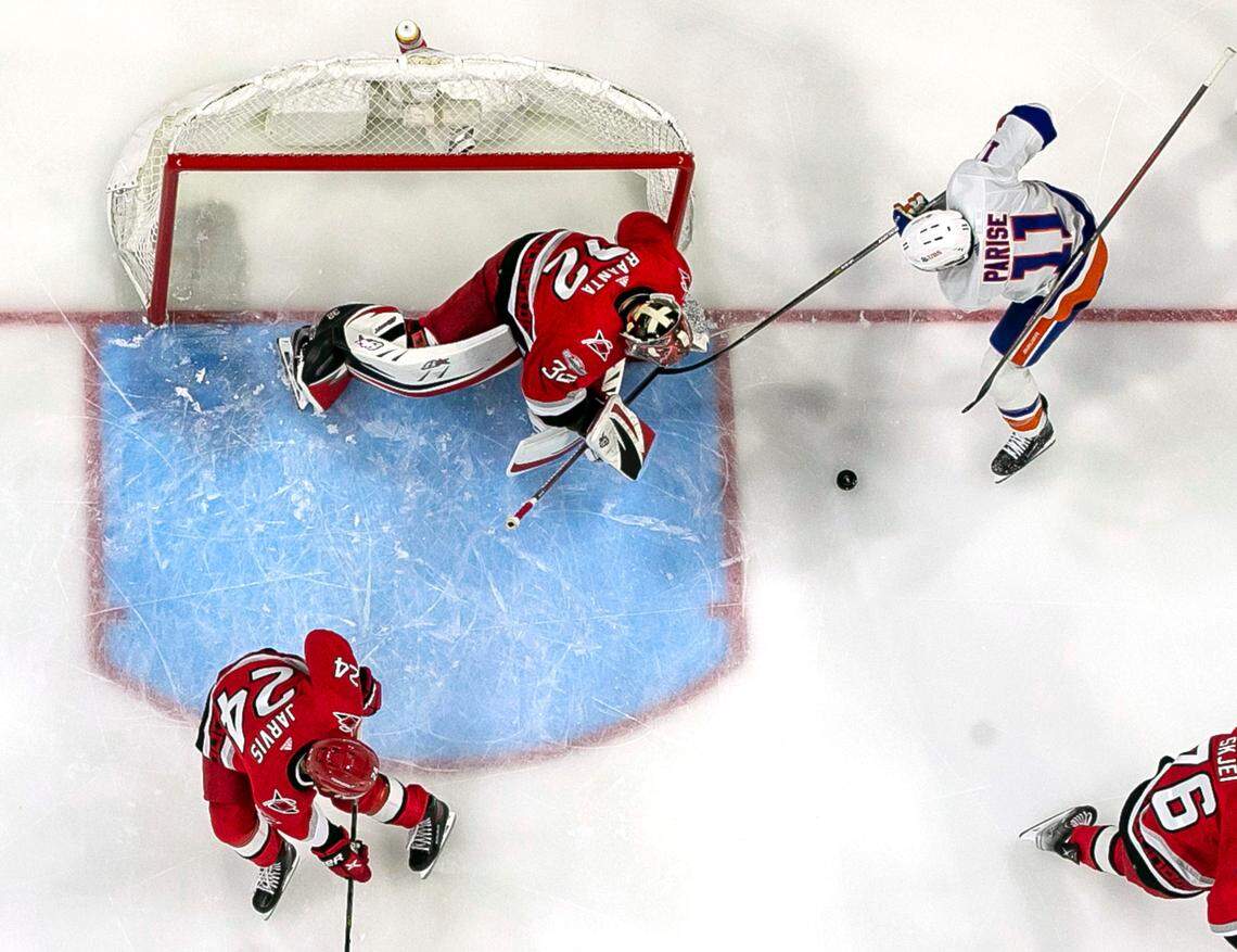 Carolina Hurricanes goalie Antii Raanta (32) stops a scoring attempt by New York Islanders’ Zach Parise (11) in the first period on Monday, April 17, 2023 at PNC Arena in Raleigh, N.C.