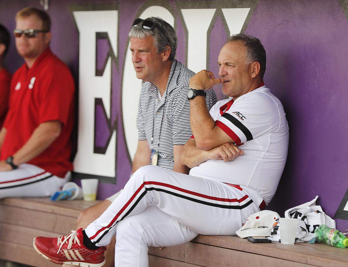 N.C. State head coach Elliott Avent and director of athletics Boo Corrigan watch during a rain delay during N.C. State's game against Campbell in the Greenville Regional at Clark-LeClair Stadium in Greenville, N.C., Friday, May 31, 2019.