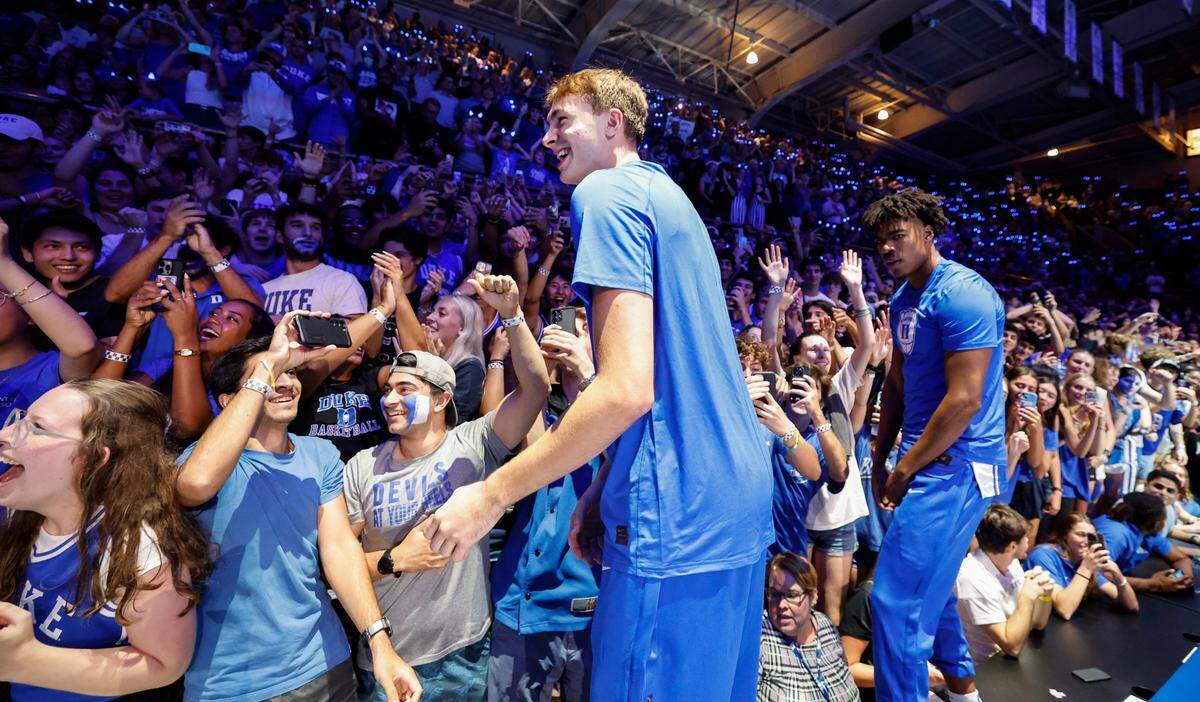 Duke’s Cooper Flagg and the team jump on the press table during the Blue Devils’ Countdown to Craziness at Cameron Indoor Stadium in Durham, N.C., Friday, Oct. 4, 2024. Duke’s Cameron Sheffield (13) is to the right.