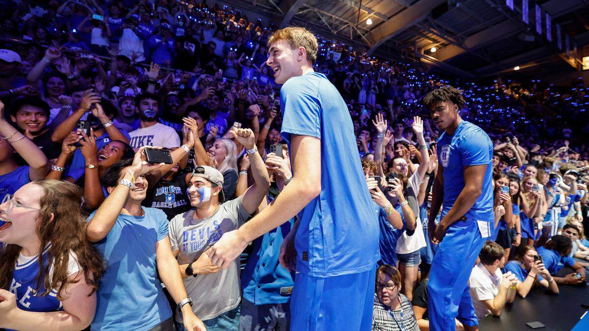 Duke’s Cooper Flagg and the team jump on the press table during the Blue Devils’ Countdown to Craziness at Cameron Indoor Stadium in Durham, N.C., Friday, Oct. 4, 2024. Duke’s Cameron Sheffield (13) is to the right.