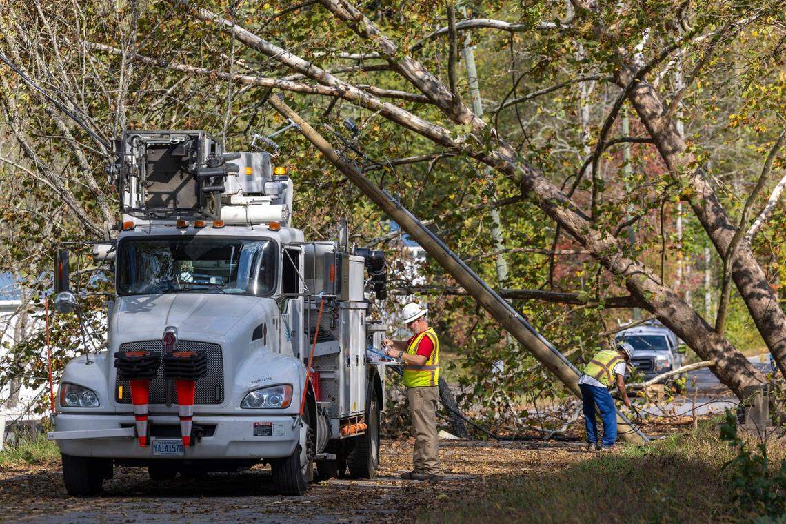 AT&T linemen from Asheville, N.C. work to restore communication lines destroyed by Hurricane Helene along the banks of the Broad River on Sunday, October 6, 2024 in rural Buncombe County, near Black Mountain, N.C.