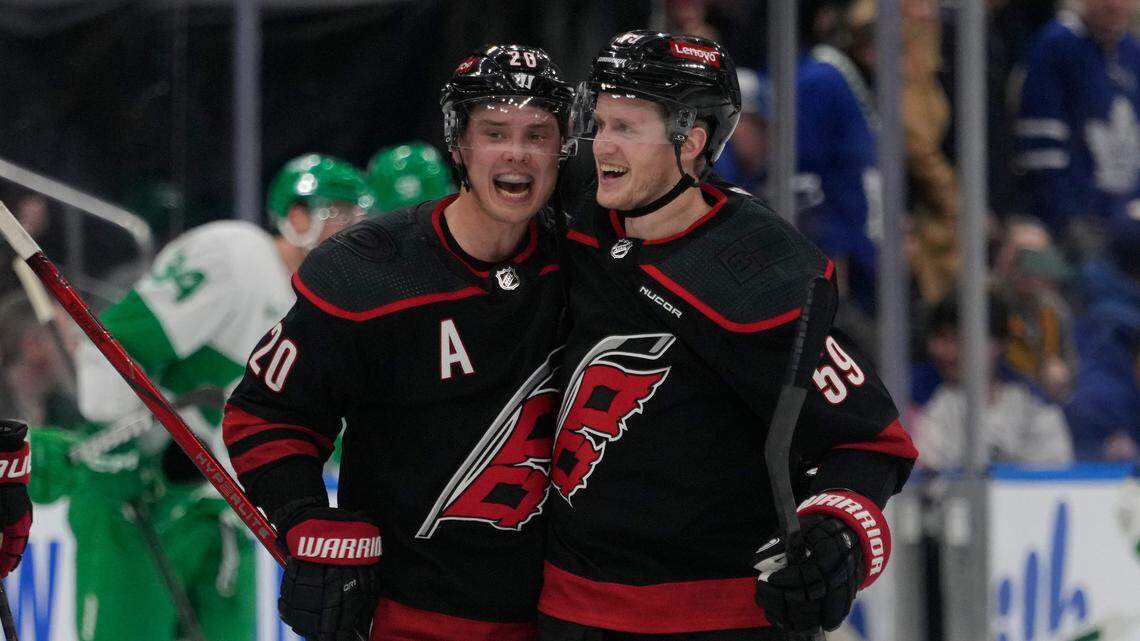 Carolina Hurricanes forward Sebastian Aho (20) congratulates forward Jake Guentzel (59) for scoring the winning shootout goal against the Toronto Maple Leafs on Saturday.