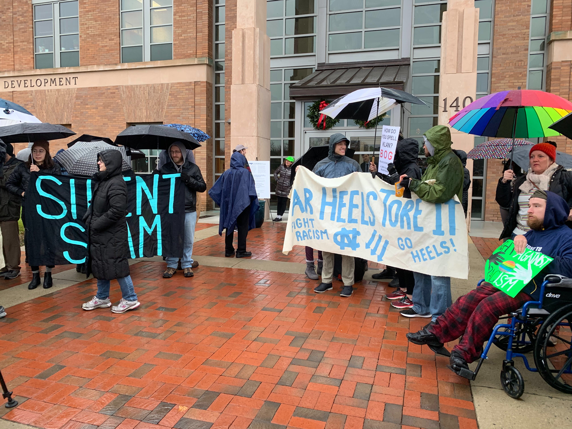 Protesters gather in Chapel Hill on Friday morning to protest the UNC System’s Silent Sam deal.