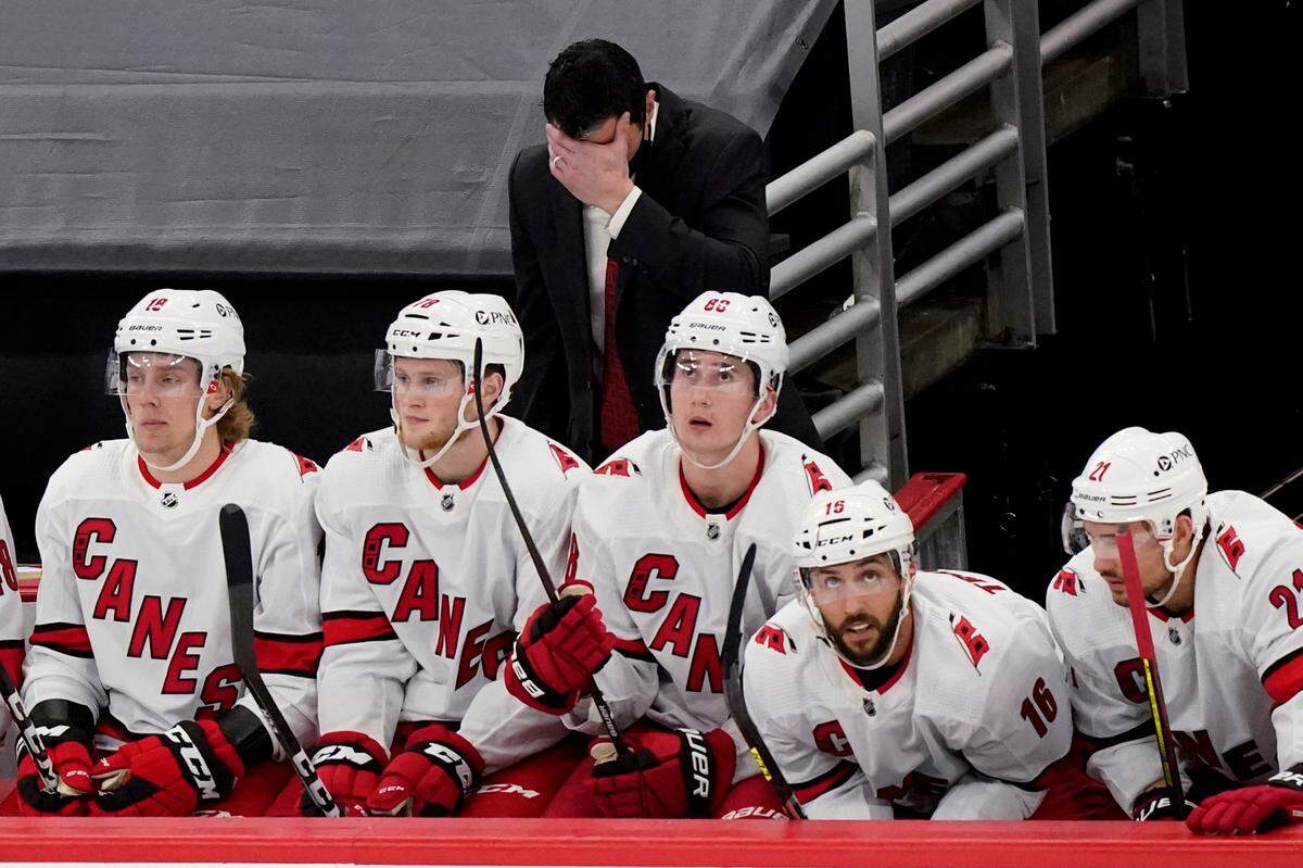 Carolina Hurricanes coach Rod Brind’Amour, top, reacts after Chicago Blackhawks’ Alex DeBrincat scored a goal during the third period of an NHL hockey game in Chicago, Thursday, Feb. 4, 2021. (AP Photo/Nam Y. Huh)