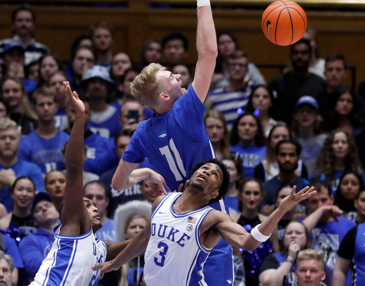 Duke’s Jaylen Blakes and Jeremy Roach battle for a loose ball with Hofstra’s Jacco Fritz during the second half of the Blue Devils’ 89-68 win on Tuesday, Dec. 12, 2023, at Cameron Indoor Stadium in Durham, N.C.