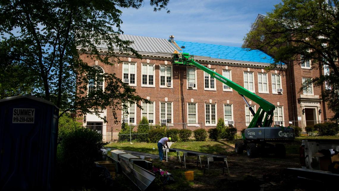 A roofing crew installs a new metal roof on the Durham School of the Arts, on Tuesday, Apr. 20, 2021, in Durham, N.C.