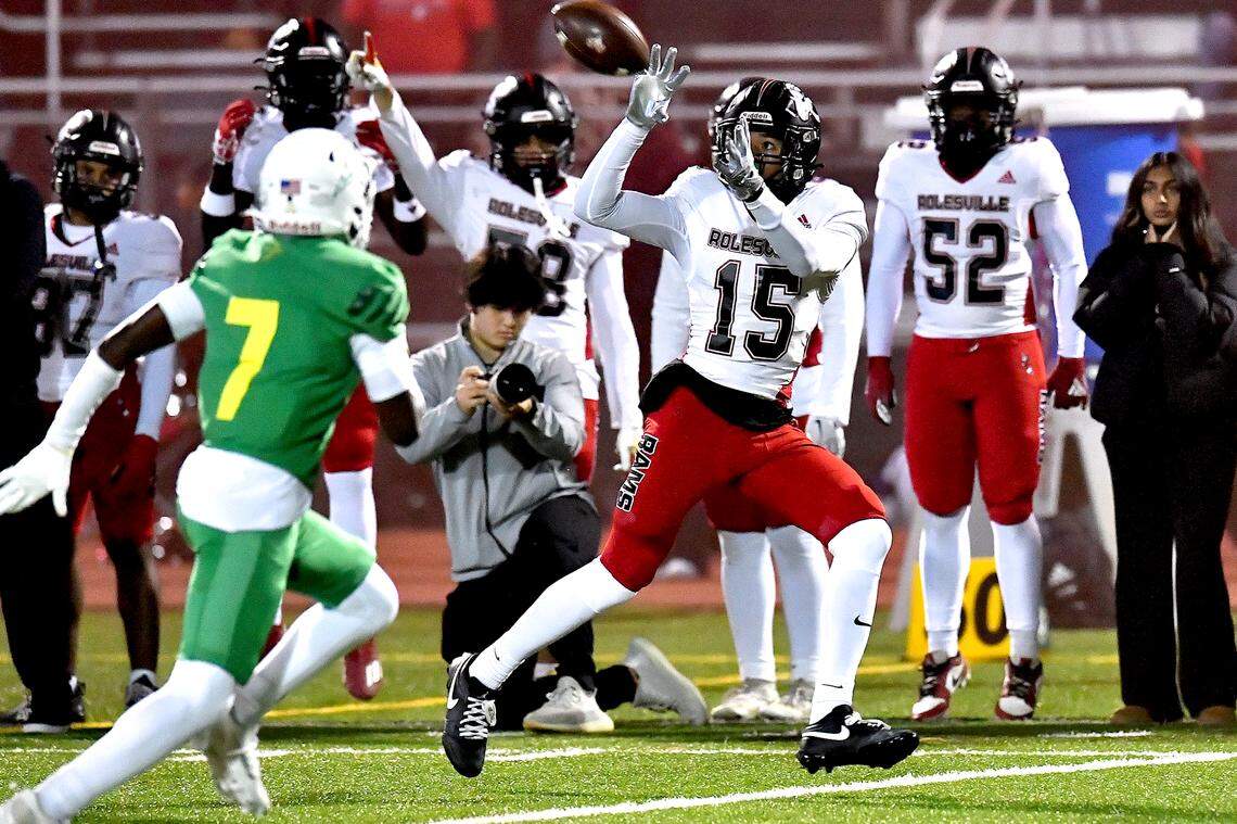 Rolesville wide receiver AJ Roberts (15) focuses on the ball for the catch against Cardinal Gibbons during the first half. The Rolesville Rams and the Cardinal Gibbons Crusaders met in the East Regional Final of the NCHSAA 4A football playoffs in Raleigh, N.C. on December 13, 2024.