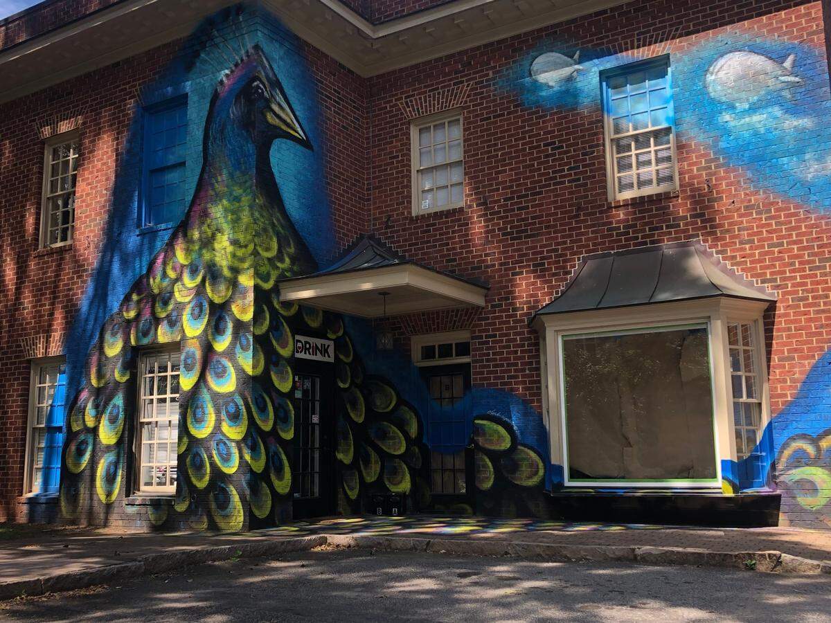 Pavo the Peacock, painted by Clark Hipolito in 2019, gazes out on Glenwood avenue from the corner of Drink.