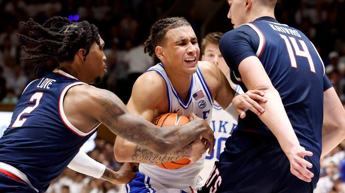 Duke’s Tyrese Proctor (5) tries to get by Arizona’s Caleb Love (2) and Motiejus Krivas (14) during the first half of Duke’s game against Arizona at Cameron Indoor Stadium in Durham, N.C., Friday, Nov. 10, 2023.