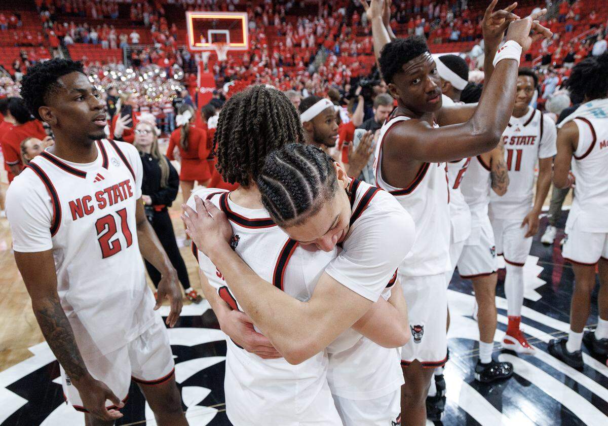 N.C. State’s Jordan Snell and Matt Able celebrate following the Wolfpack’s 82-58 win over North Carolina on Tuesday, Feb. 17, 2026, at Lenovo Center in Raleigh, N.C.