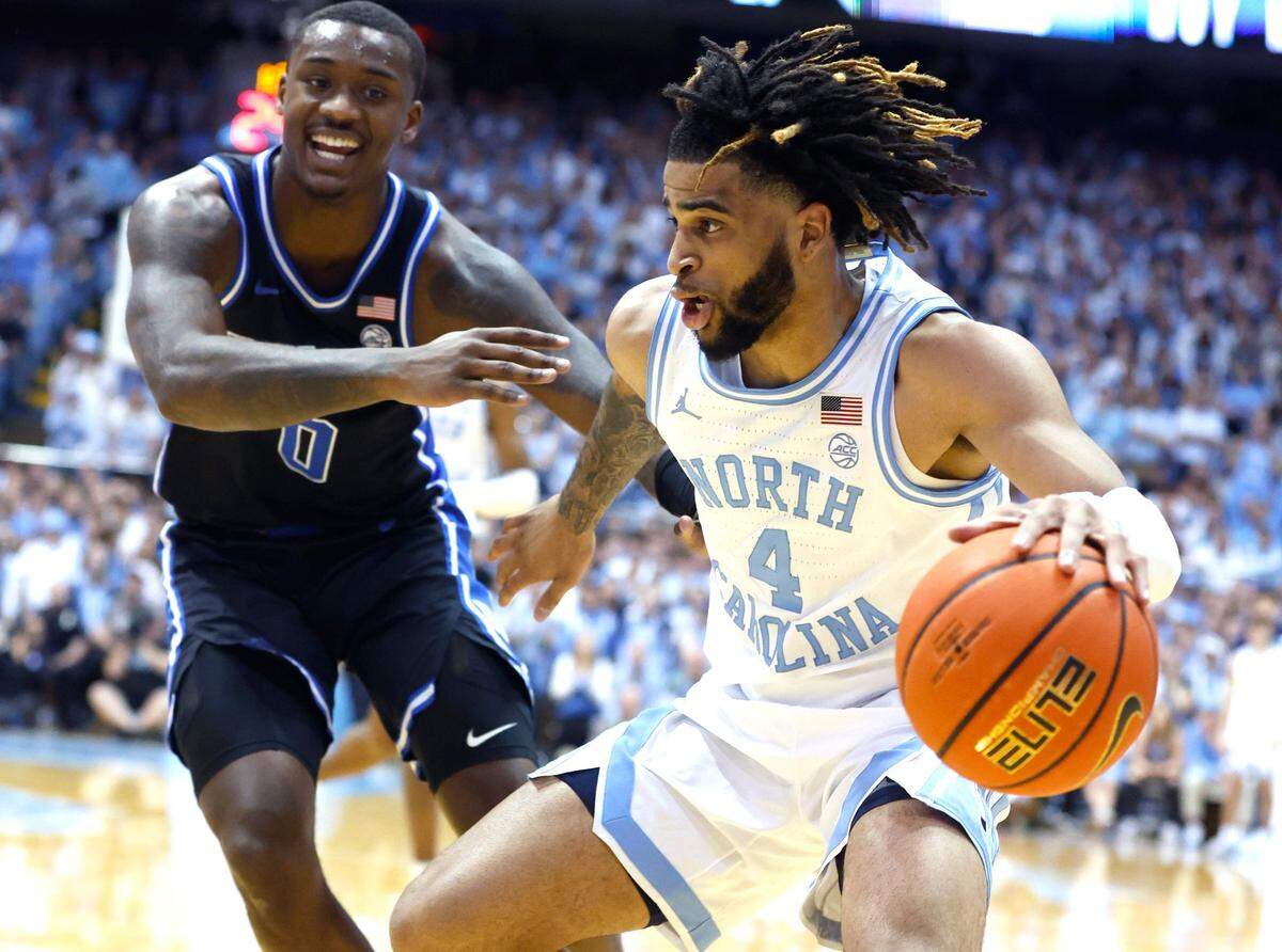 North Carolina’s RJ Davis (4) brings the ball past Duke’s Dariq Whitehead (0) during the first half of UNC’s game against Duke at the Smith Center in Chapel Hill, N.C., Saturday, March 4, 2023.