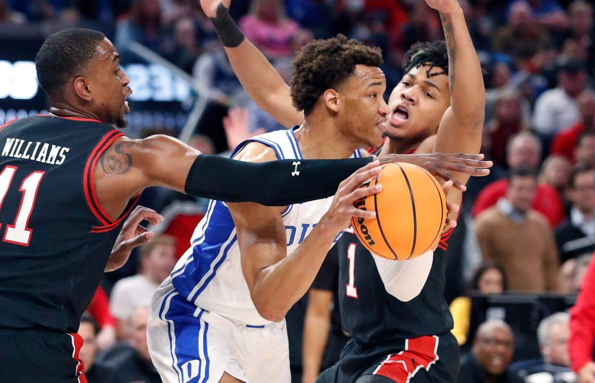 Dukes Wendell Moore Jr. (0) escapes the pressure of Texas Tech’s Bryson Williams (11) and Terrence Shannon Jr. (1) during the first half of Dukes game against Texas Tech in the Sweet 16 round of the NCAA Tournament at the Chase Center in San Francisco, Calif., Thursday, March 24, 2022.