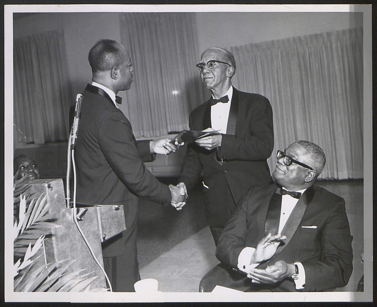 St. Augustine’s University President Prezell Robinson is at left.