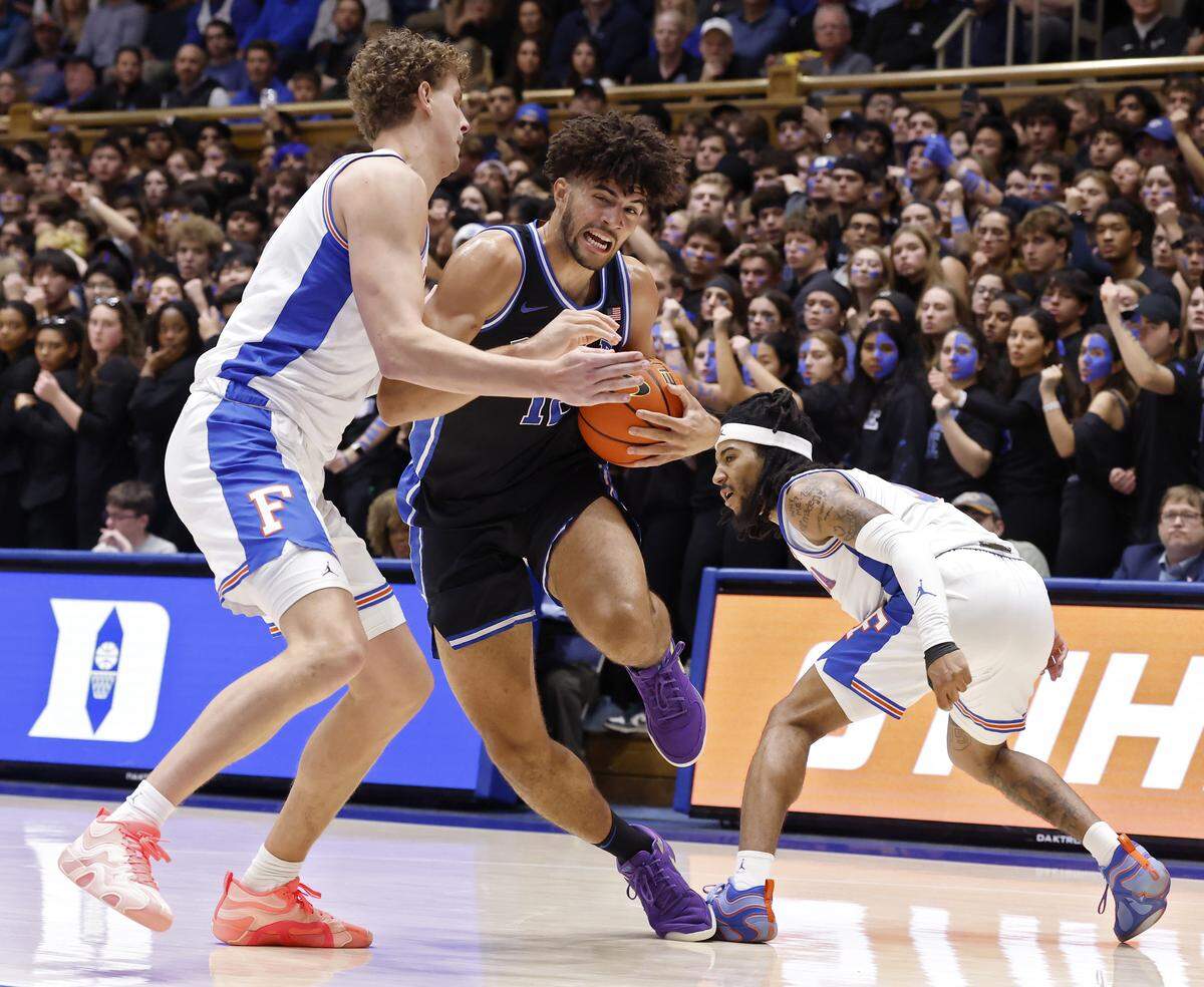 Duke’s Cameron Boozer drives between Florida's Micah Handlogten and Florida's Boogie Fland during the first half of the Blue Devils’ game in the ACC/SEC Challenge on Tuesday, Dec. 2, 2025 at Cameron Indoor Stadium in Durham, N.C.