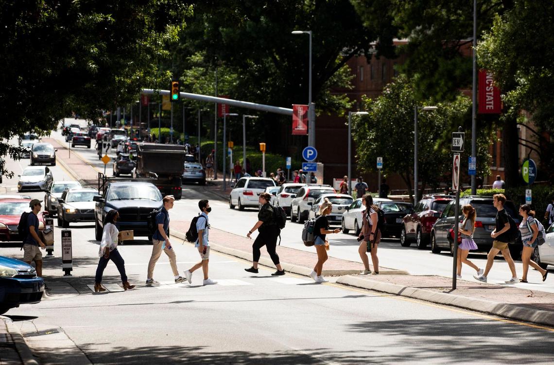 N.C. State students cross Hillsborough Street on the first day of classes for the fall semester, on Monday, Aug. 16, 2021, in Raleigh, N.C.