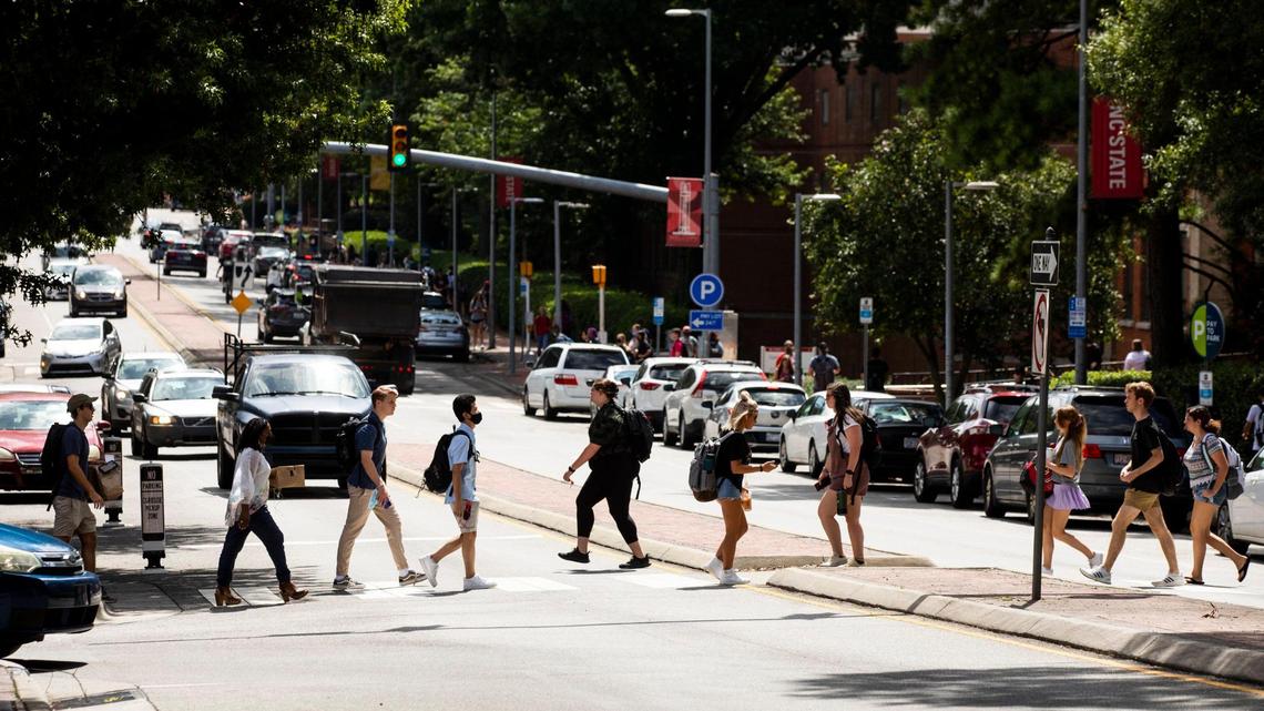 N.C. State students cross Hillsborough Street on the first day of classes for the fall semester, on Monday, Aug. 16, 2021, in Raleigh, N.C.