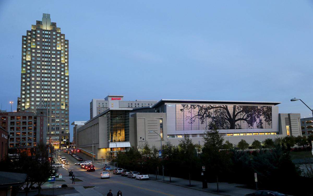The city of Raleigh as begun turning off lights at some of its downtown buildings late at night for the benefit of songbirds who migrate through North Carolina each fall and spring. Both the lights used to illuminate the exteriors of buildings as well as lights left on inside can confuse birds, coaxing them to fly into walls of glass or fly in circles until they get exhausted and drop. Here the Shimmer Wall on the Raleigh Convention Center, right, is seen at dusk on Monday, Nov. 16, 2015.