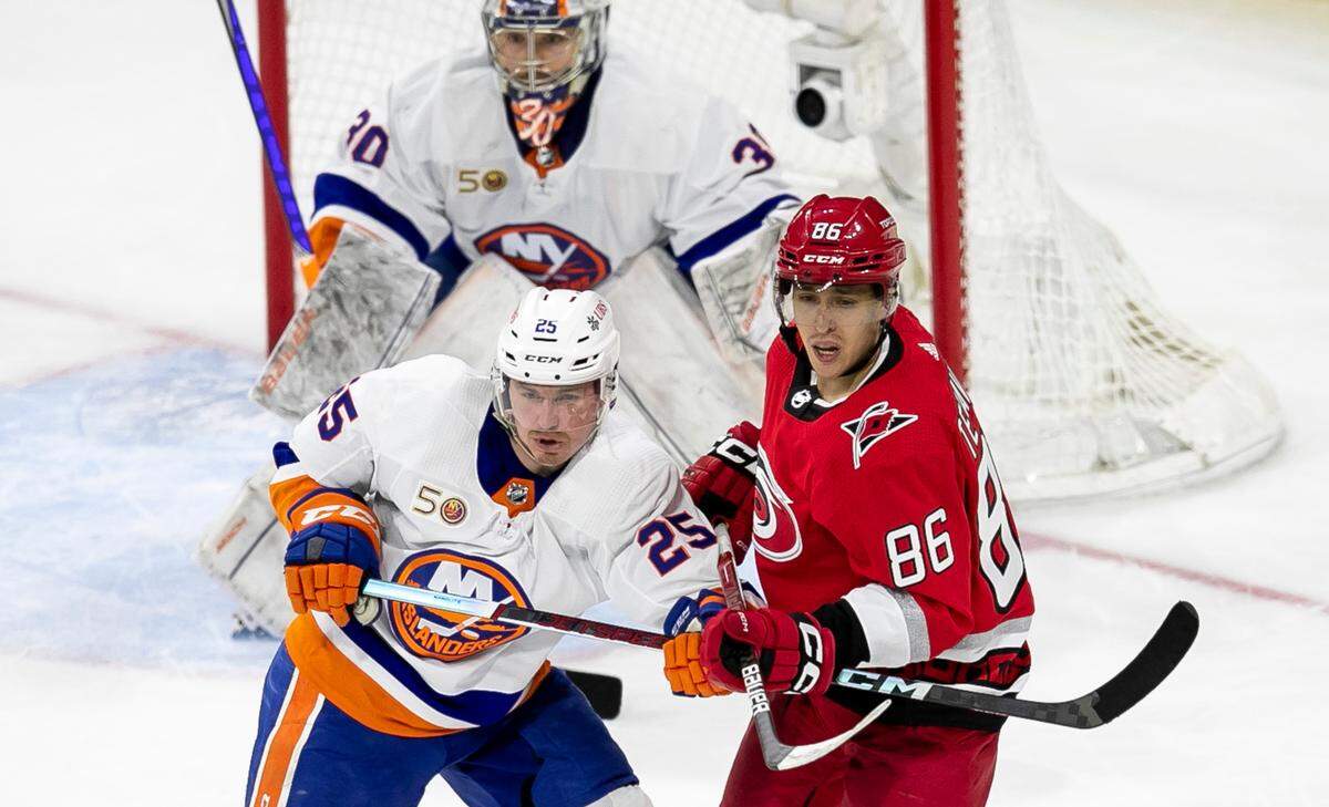 The Carolina Hurricanes Teuvo Teravainen (86) battles for position in front of New York Islanders goalie Ilya Sorokin (30) in the second period during Game 2 of their Stanley Cup series on Wednesday, April 19, 2023 at PNC Arena in Raleigh, N.C. Teravainen suffered a broken hand in the third period.