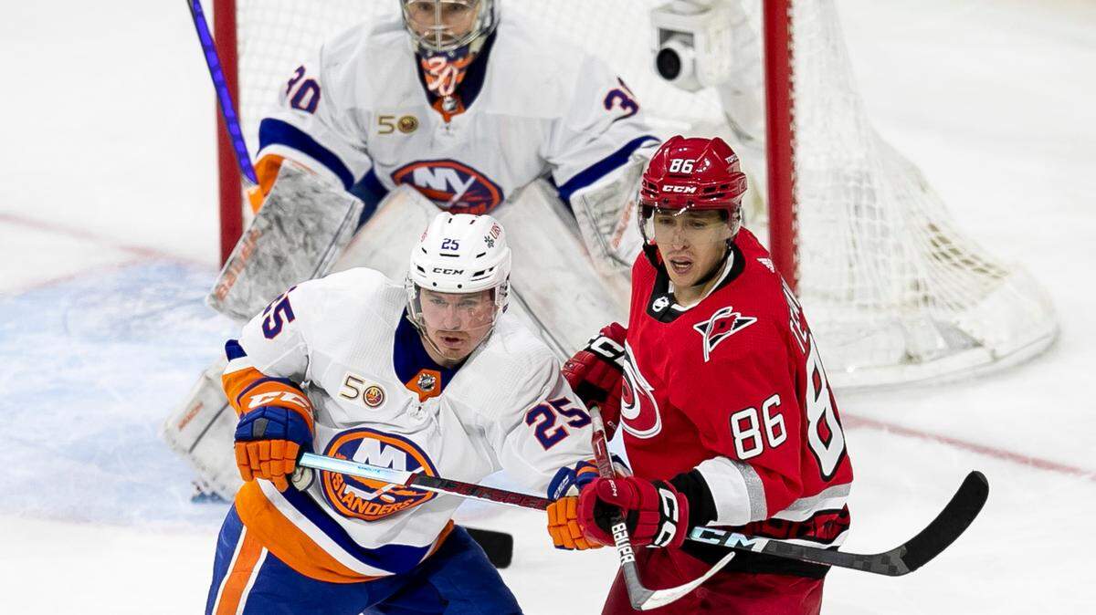 The Carolina Hurricanes Teuvo Teravainen (86) battles for position in front of New York Islanders goalie Ilya Sorokin (30) in the second period during Game 2 of their Stanley Cup series on Wednesday, April 18, 2023 at PNC Arena in Raleigh, N.C. Teravainen suffered a broken hand in the third period.