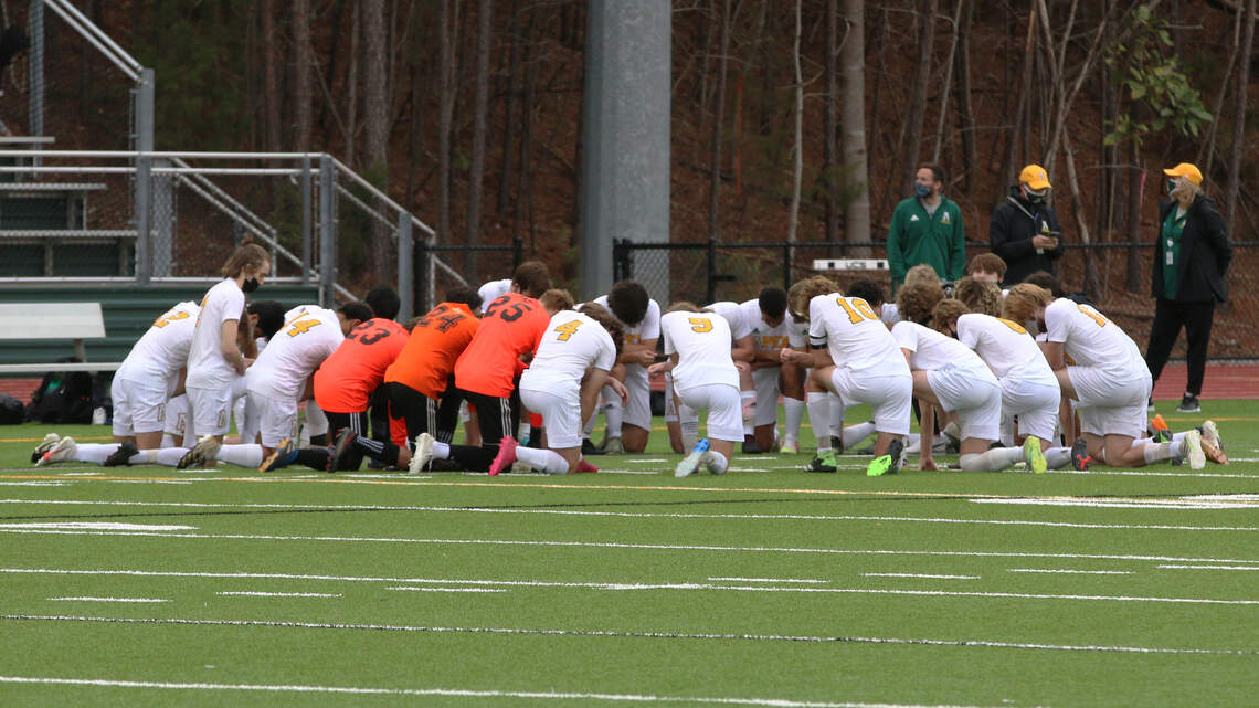 Raleigh-area high school soccer team overcomes death of their coach — together