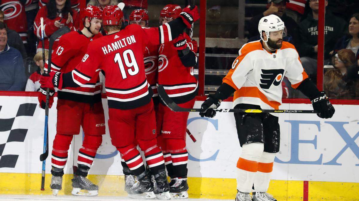 The Carolina Hurricanes celebrate a goal by Andrei Svechnikov as Philadelphia Flyers’ Radko Gudas (3) skates by during the second period of an NHL hockey game, Monday, Dec. 31, 2018, in Raleigh, N.C. (AP Photo/Karl B DeBlaker)