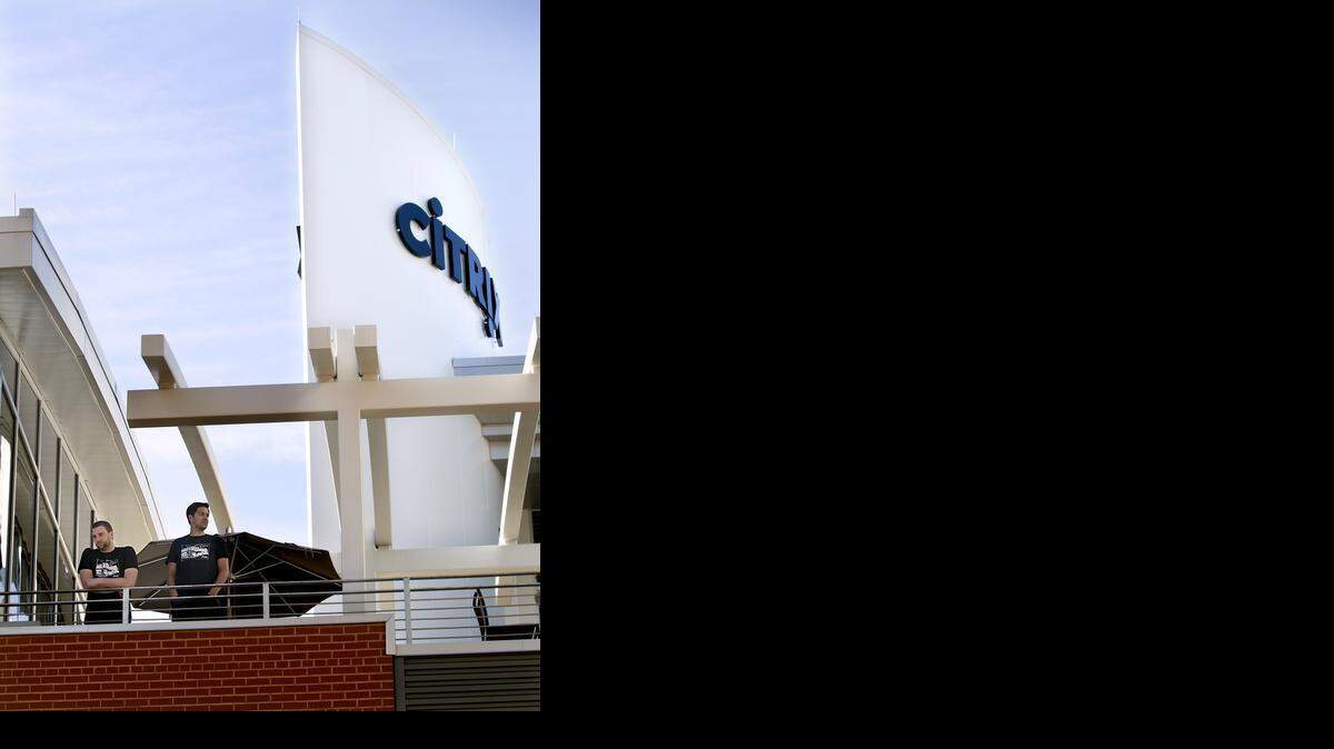 Employees get a view of the city from the rooftop deck at the new Citrix office building in downtown Raleigh on Thursday, Oct. 9, 2014.
