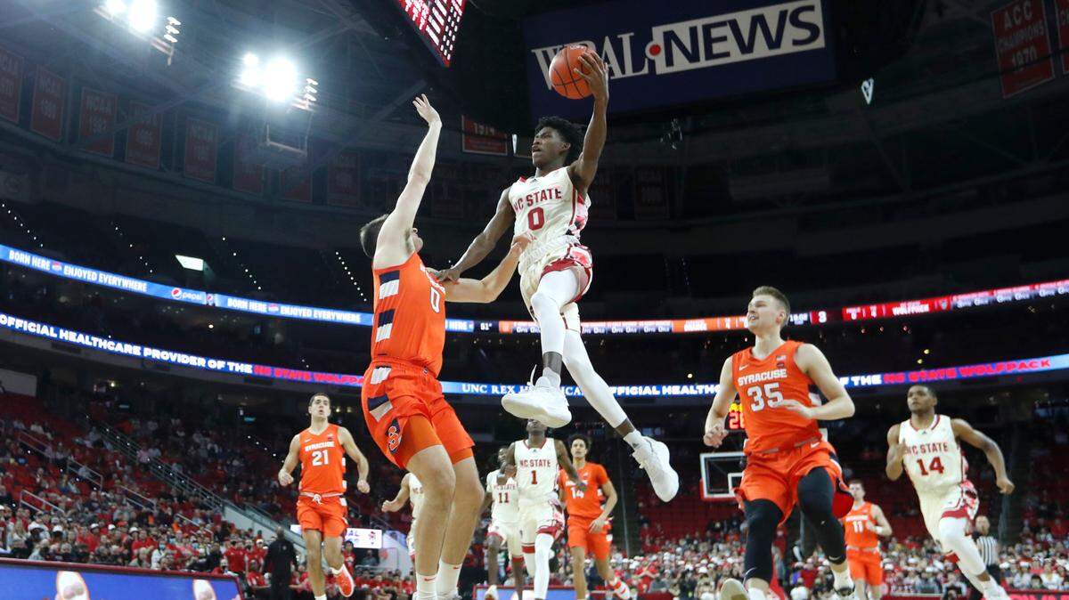 N.C. State’s Terquavion Smith (0) heads to the basket as Syracuse’s Jimmy Boeheim (0) defends during Syracuse’s 89-82 victory over N.C. State at PNC Arena in Raleigh, N.C., Wednesday, Feb. 2, 2022.