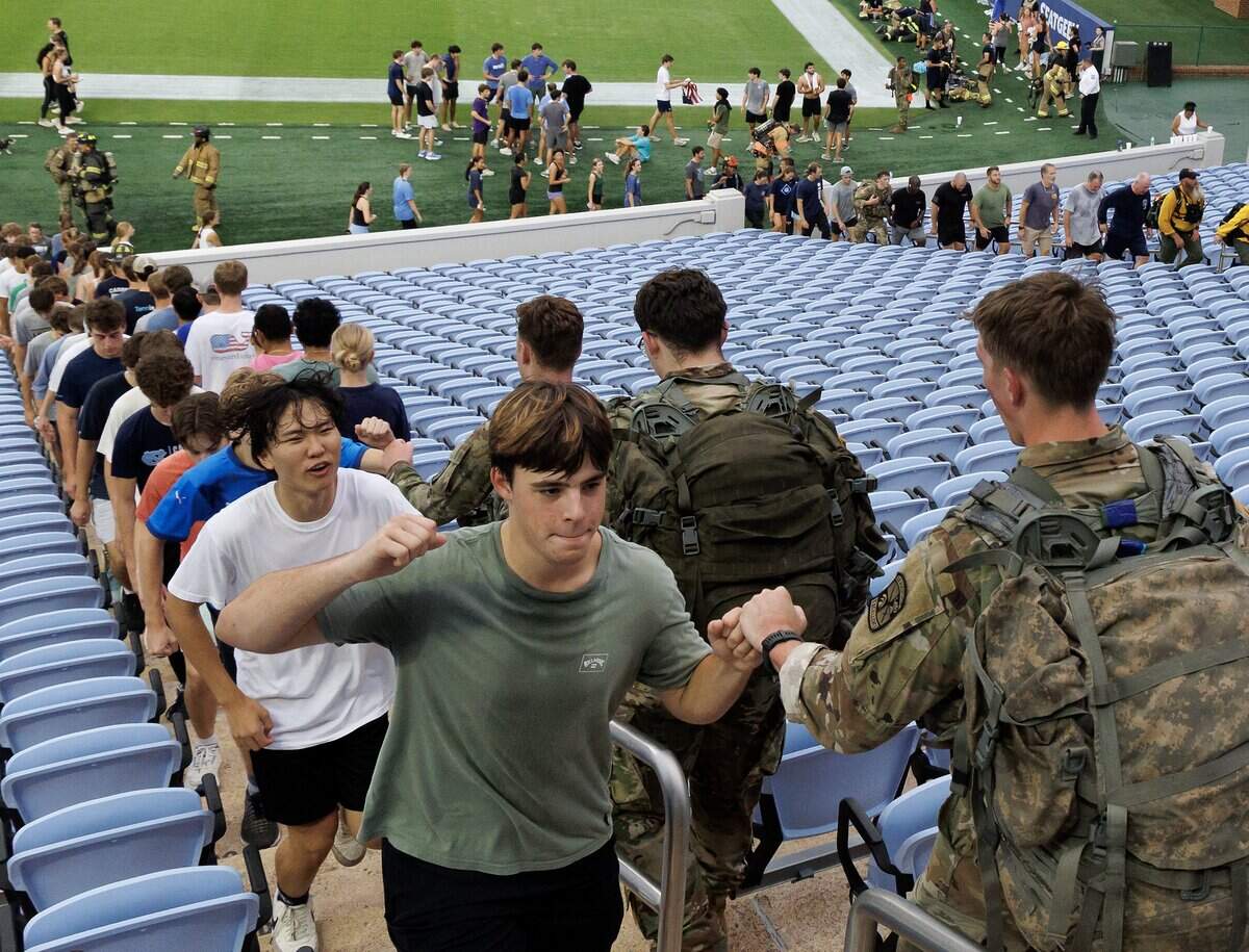 Participants share words of encouragement during a memorial stair climb at Kenan Memorial Stadium on Thursday, Sept. 11, 2025, held to honor those who lost their lives during attacks of Sept. 11, 2001.