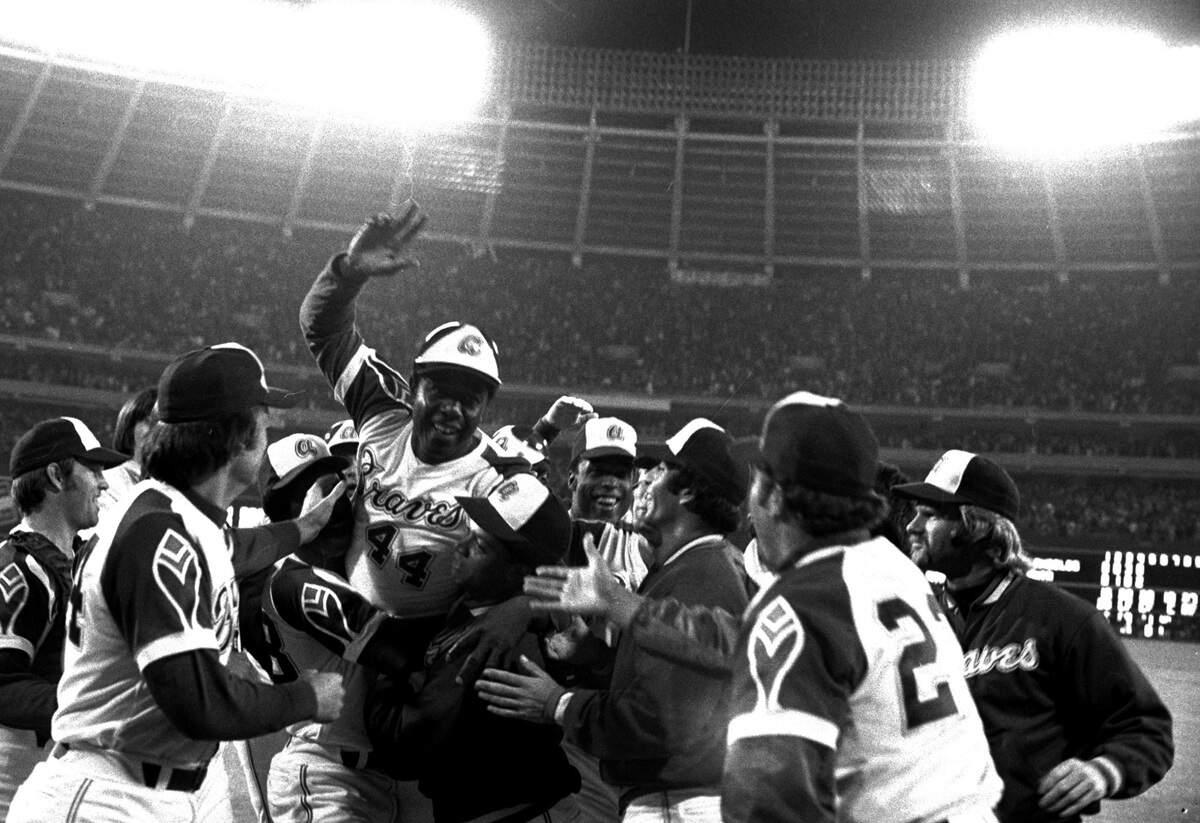 Teammates extend their congratulations as they greet Hank Aaron at home plate en route to dugout after hitting his 715th career home run in a game Monday night, April 8, 1974 against the Los Angeles Dodgers.