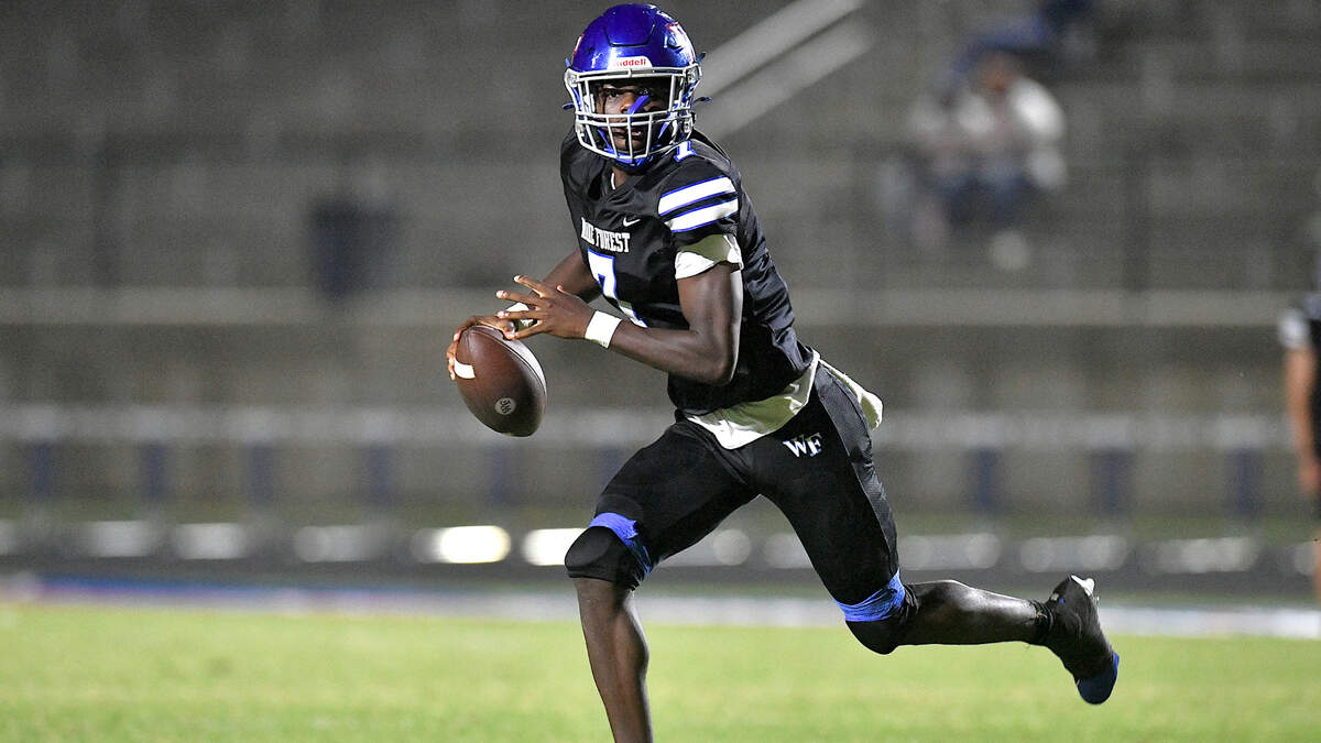 Wake Forest quarterback Kavon Simmons (7) runs and looks to pass downfield against Clayton during the second half of their game. The Wake Forest Cougars and the Clayton Comet met in a non-conference football game in Wake Forest, N.C. on August 23, 2024.