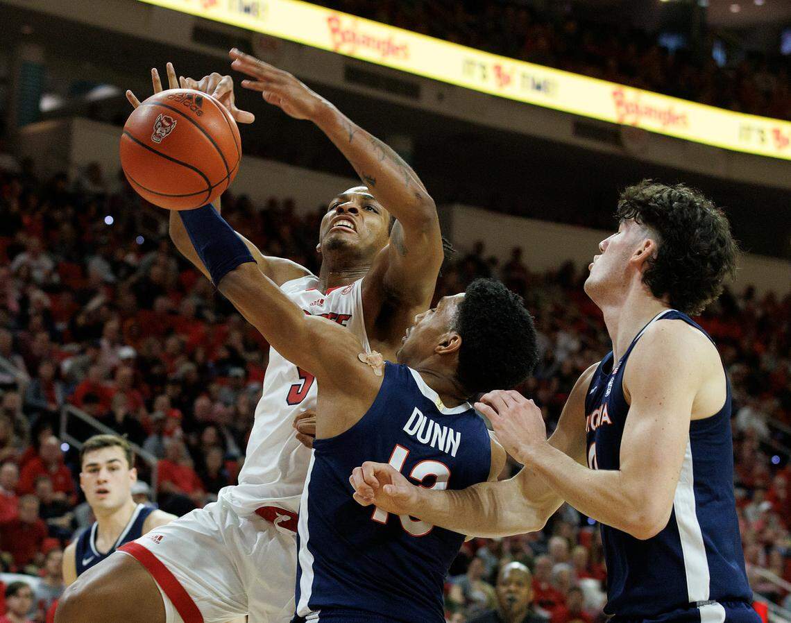 Virginia’s Ryan Dunn swipes the ball away from N.C. State’s MJ Rice during the second half of the Wolfpack’s 76-60 win on Saturday, Jan. 6, 2024, at PNC Arena in Raleigh, N.C.