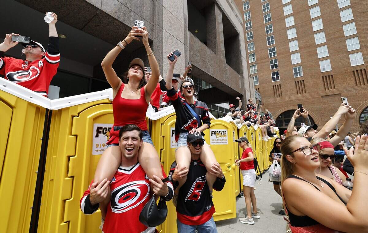 From left, Isabella Soltz with her boyfriend Cody Keister and Keegan Abar with her boyfriend Mathew Kubilins cheer during the rally for the Carolina Hurricanes in downtown Raleigh Saturday, June 20, 2026.