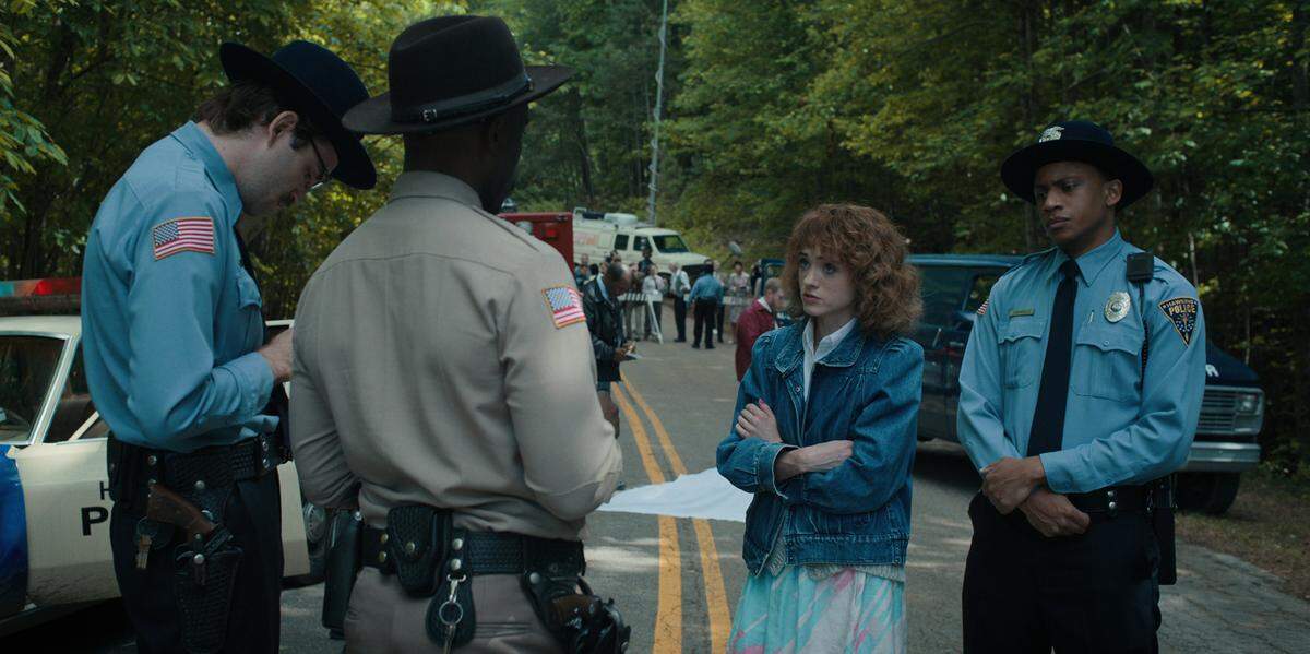 (L to R) John Paul Reynolds as Officer Callahan, Rob Morgan as Officer Powell and Natalia Dyer as Nancy Wheeler in Season 4 of the Netflix series “Stranger Things.”
