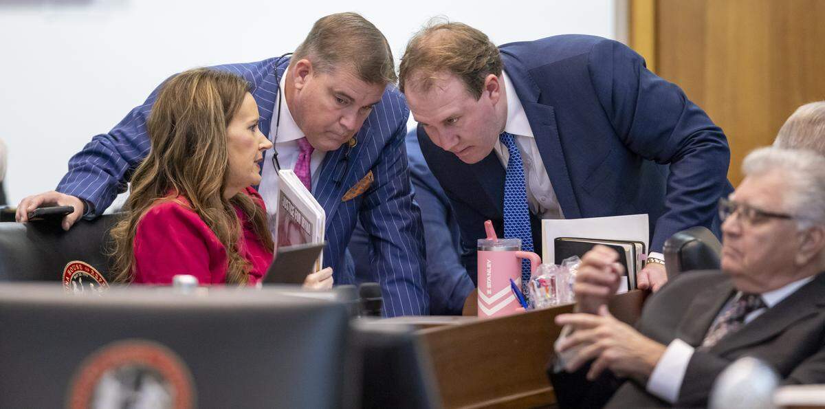Rep. Tricia Cotham and Rep. Brenden Jones confer with legislative staff member Kenan Drum during debate on House Bill 307, “Iryna’s Law,” on Sept. 23, 2025, at the NC General Assembly in Raleigh.