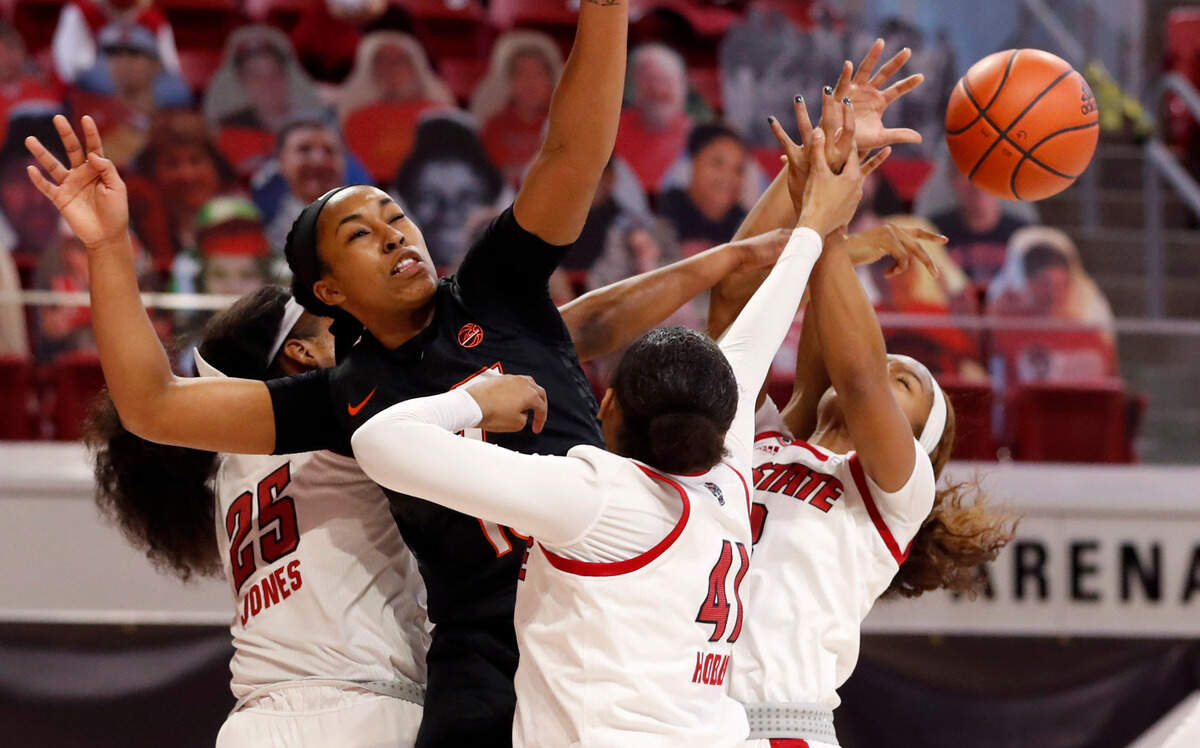 Virginia Tech’s Azana Baines (15) along with N.C. State’s Kayla Jones (25), Camille Hobby (41) and Kai Crutchfield (3) go after the rebound during the first half of N.C. State’s game against Virginia Tech at Reynolds Coliseum in Raleigh, N.C., Sunday, January 24, 2021.