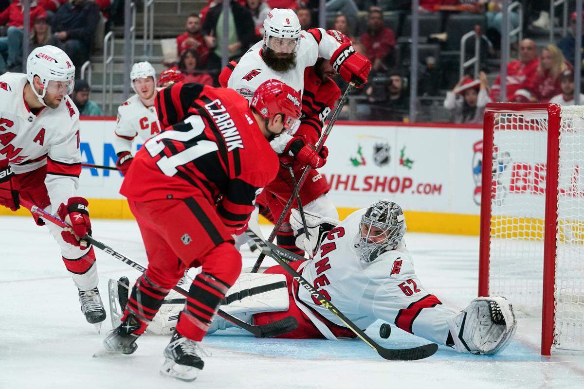 Carolina Hurricanes goaltender Pyotr Kochetkov (52) stops a Detroit Red Wings center Austin Czarnik (21) shot in the second period of an NHL hockey game Tuesday, Dec. 13, 2022, in Detroit. (AP Photo/Paul Sancya)