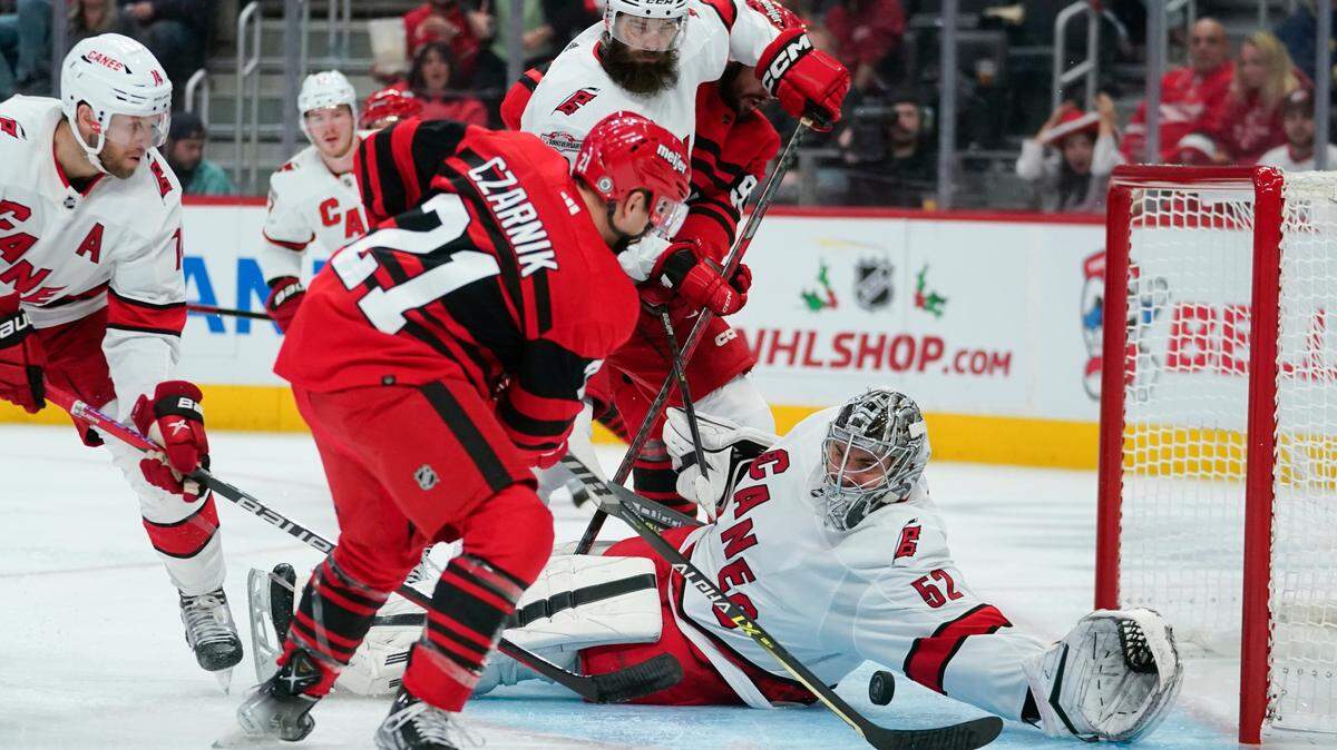Carolina Hurricanes goaltender Pyotr Kochetkov (52) stops a Detroit Red Wings center Austin Czarnik (21) shot in the second period of an NHL hockey game Tuesday, Dec. 13, 2022, in Detroit. (AP Photo/Paul Sancya)