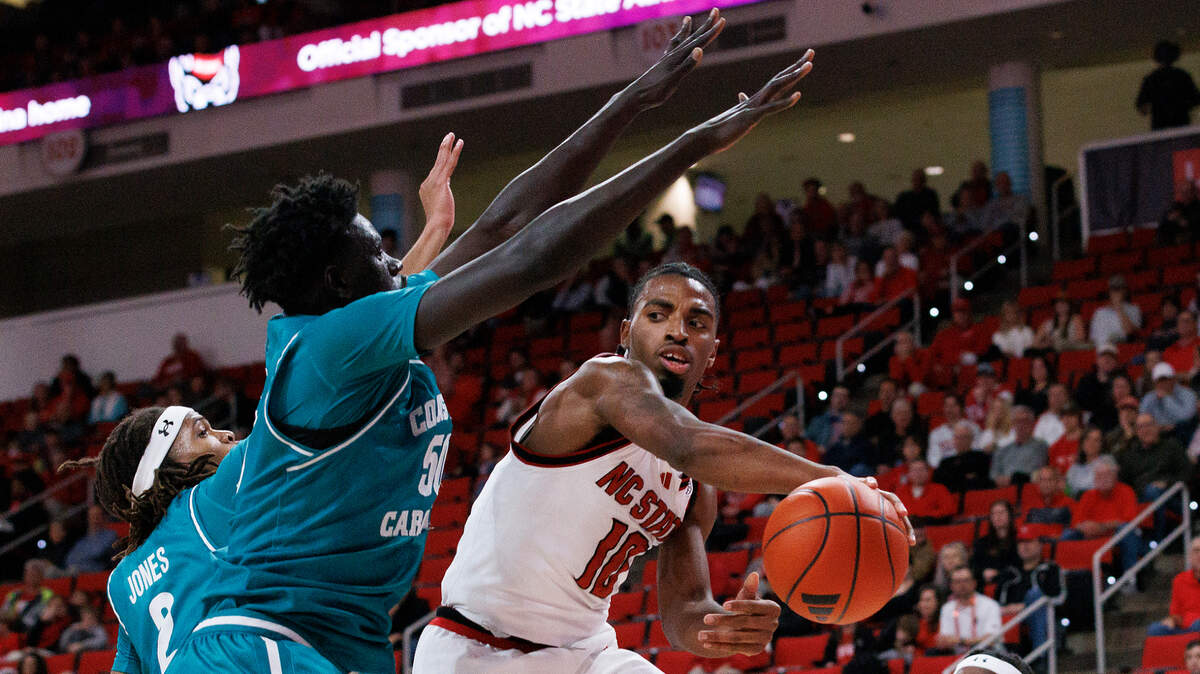 N.C. State’s Marcus Hill looks to pass around Coastal Carolina’s Mabor Majak during the first half of the Wolfpack’s game on Wednesday, Nov. 13, 2024, at Lenovo Center in Raleigh, N.C.