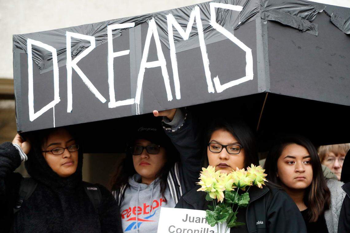 About 100 people came out to voice their opposition to many of the current immigration policies by staging a “die-in” Tuesday morning in front of Senator Tillis’s office in Raleigh to protest US Immigration policies, notably rescinding of DACA and TPS (Temporary Protective Status) March 6, 2018. Here several of them carry a mock coffin after about a half- dozen protesters pretended to play dead; they said they were symbolizing people who have died as a result of some current immigration policies.