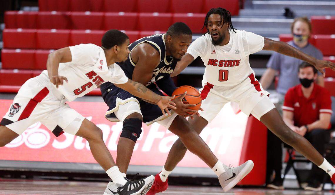 N.C. State’s Thomas Allen (5) and D.J. Funderburk (0) pressure Charleston Southern’s Ty Jones (12) during the second half of N.C. State’s 95-61 victory over Charleston Southern in the Wolfpack Invitational at Reynolds Coliseum in Raleigh, N.C., Wednesday, Nov. 25, 2020.