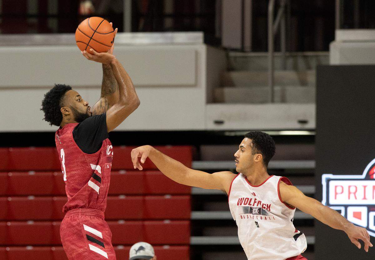 N.C. State’s Dontrez Styles shoots over teammate Ismael Diouf during a scrimmage at the Primetime with the Pack preseason event on Friday, Oct. 25, 2024, at Reynolds Coliseum in Raleigh, N.C.