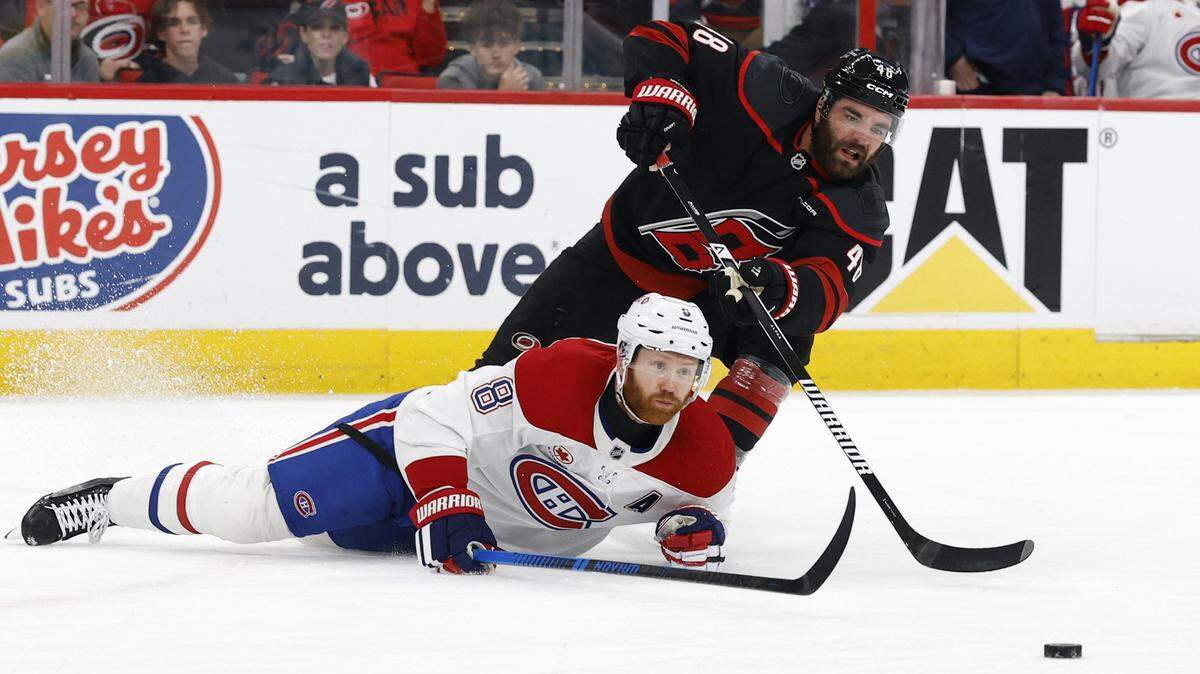 Montréal's Mike Matheson (8) and Carolina's Jordan Martinook (48) go after the puck during the first period of the Hurricanes’ game against the Canadiens in game two of the Eastern Conference Finals at the Lenovo Center in Raleigh, N.C., Saturday, May 23, 2026.