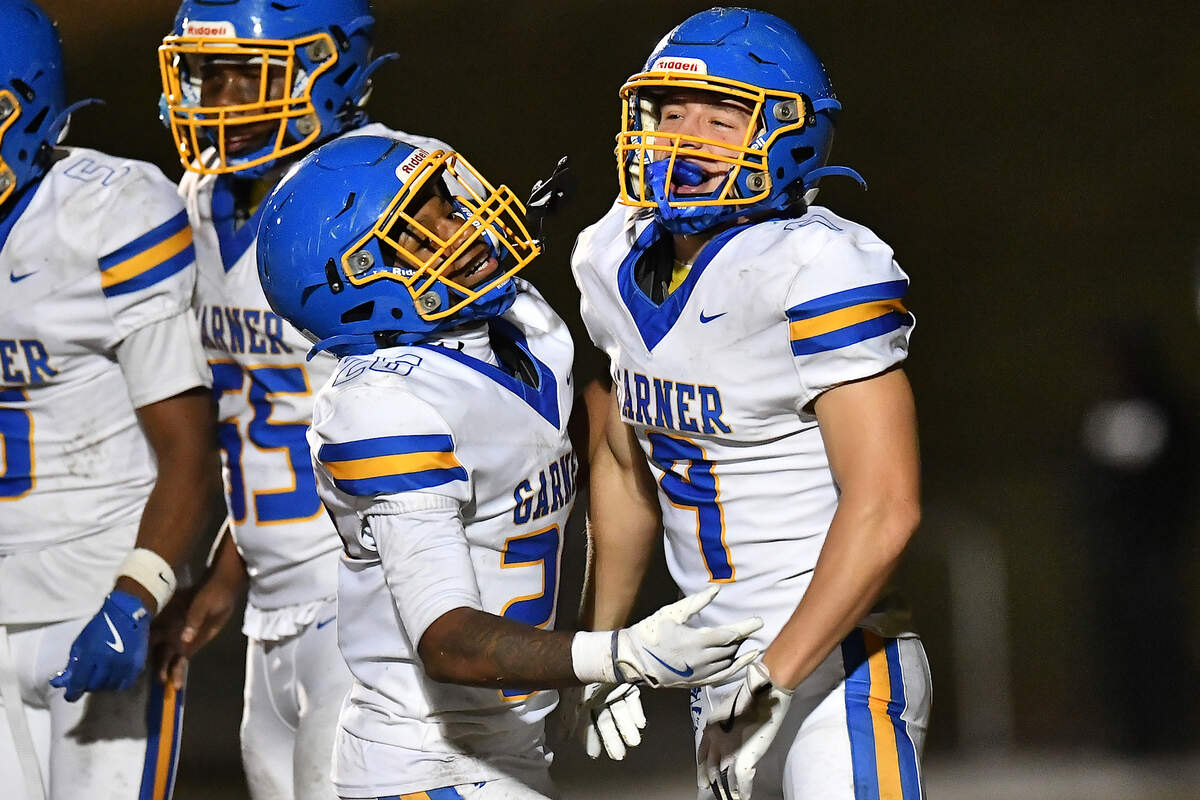 Garner running back Austin Williams (26) celebrates his touchdown against South Garner's with wide receiver Aidan Gore (9) late in the second half. The South Garner Titans and the Garner Trojans met in a conference football game in Raleigh, N.C. October 17, 2025