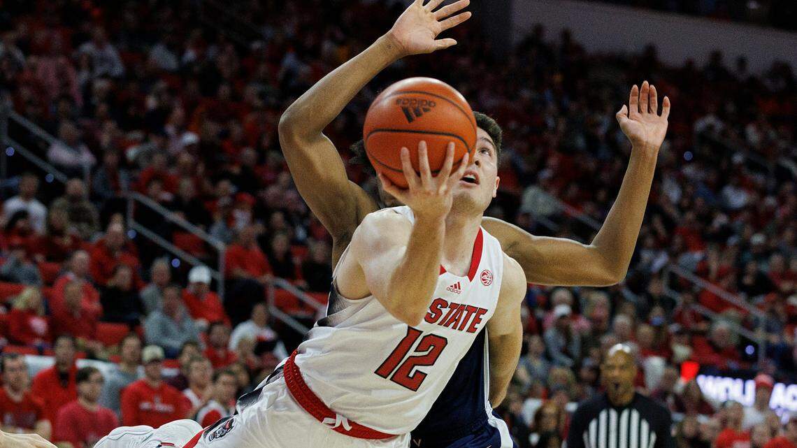 N.C. State’s Michael O’Connell drives by Virginia’s Leon Bond III during the second half of the Wolfpack’s 76-60 win on Saturday, Jan. 6, 2024, at PNC Arena in Raleigh, N.C.