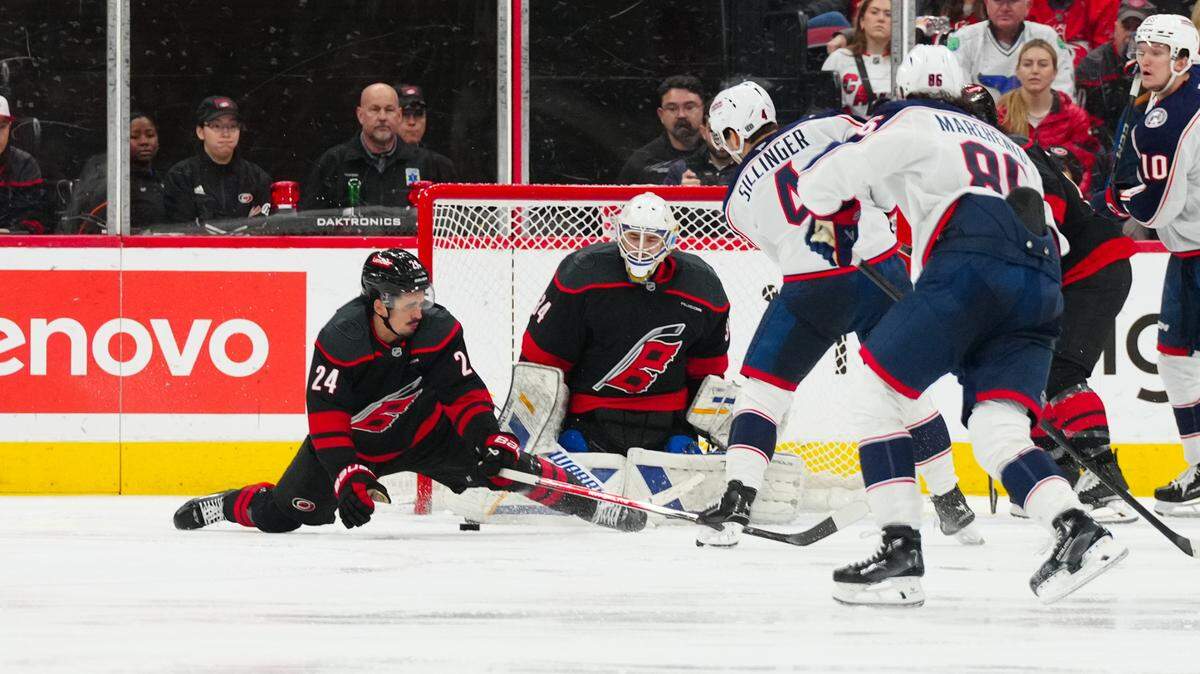 Carolina Hurricanes goaltender Dustin Tokarski (34) and center Seth Jarvis (24) stop the scoring attempt by Columbus Blue Jackets center Cole Sillinger (4) during the third period at Lenovo Center.