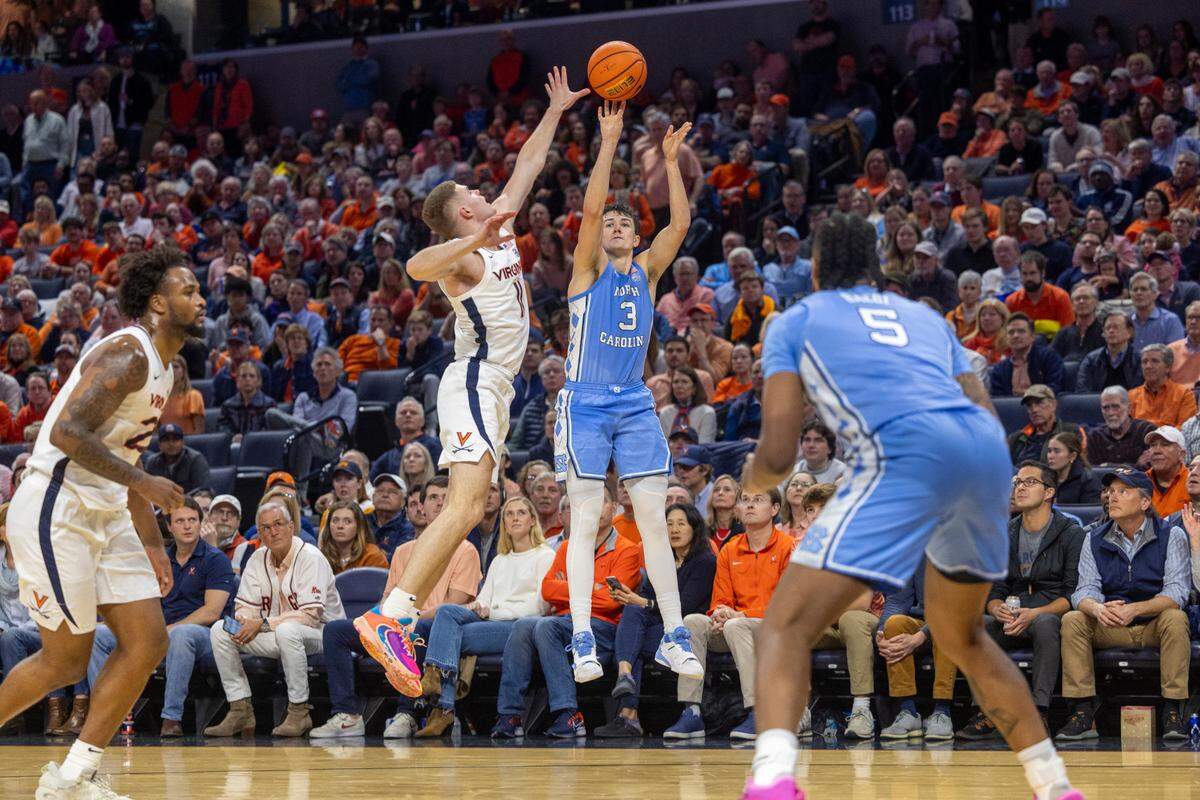 North Carolina’s Cormac Ryan (3) puts up a three point shot over Virginia’s Isaac McKneely (11) in the second half on Saturday, February 24, 2024 at John Paul Jones Arena in Charlottesville, Va.